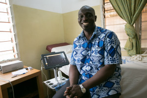 Dr. Stephen Yobo next to the new ultra sound machine. Anthon Memorial Hospital.