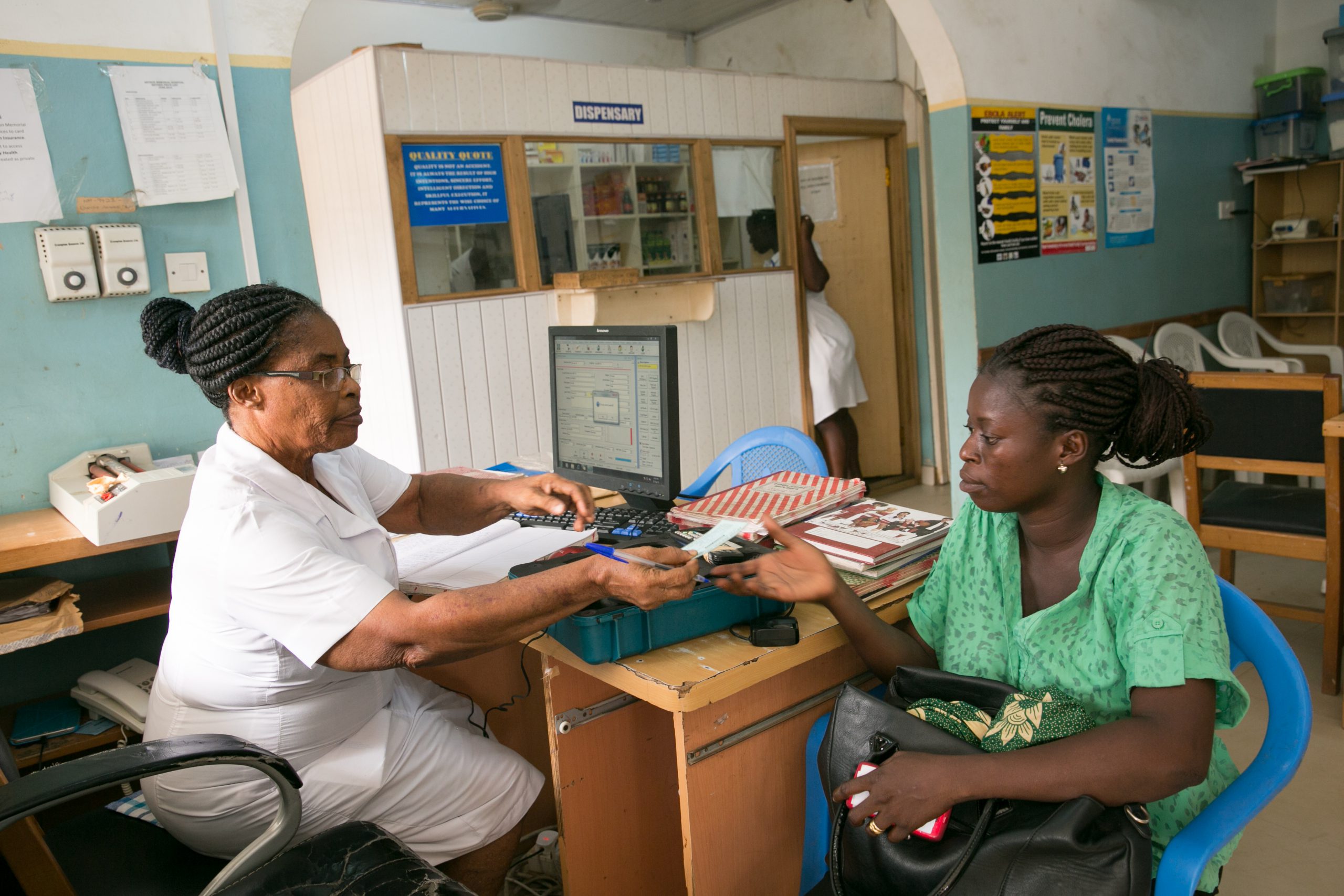 Midwife Patience Tetteh (0243452955) taking the public health insurance details from a client. Anthon Memorial Hospital.